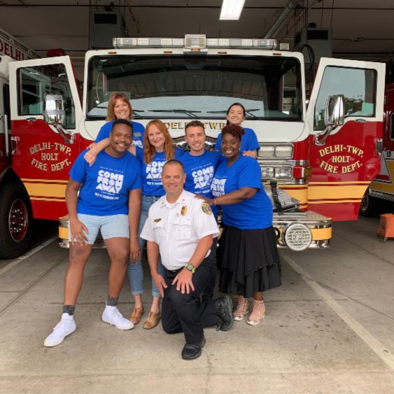 Cast and Fire Chief infront of a fire truck